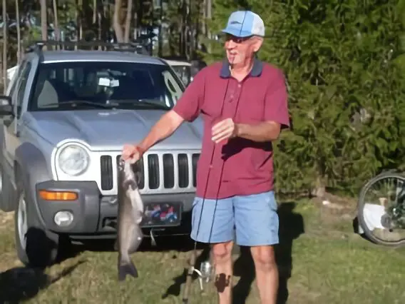 Old Man holding a catched fish